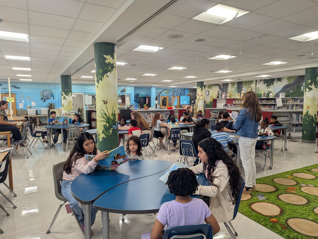 Students Reading Books to younger students