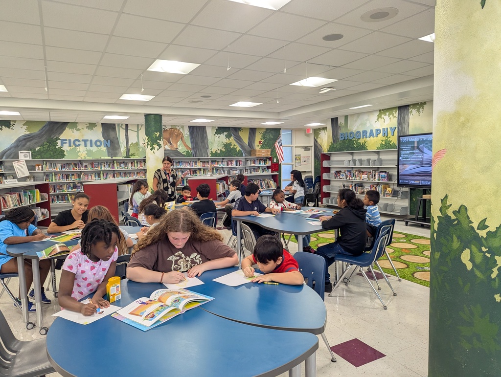 Students Reading Books to younger students