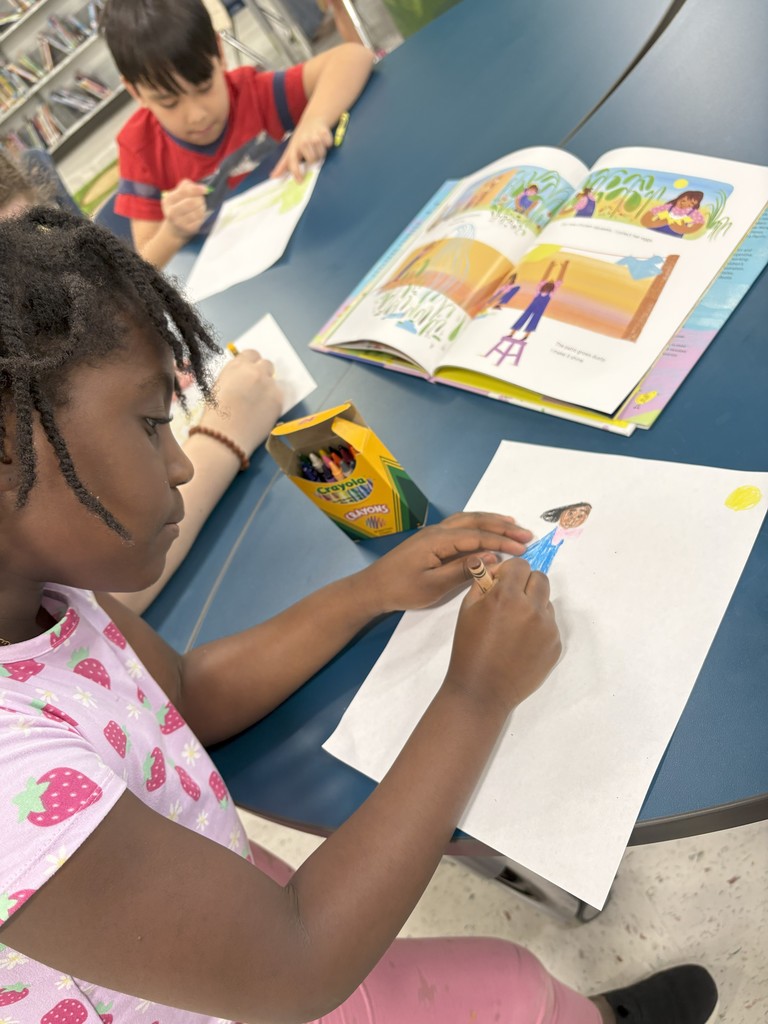 Student drawing their favorite part of a book