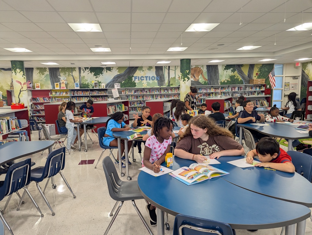 Students Reading Books to younger students