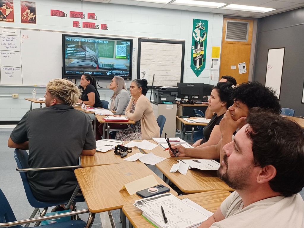 8 students watching their classmate's presentation