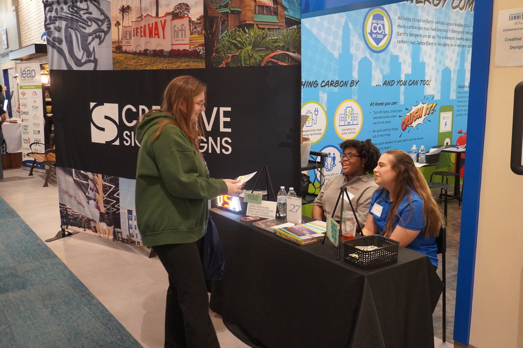 student talking to vendor table