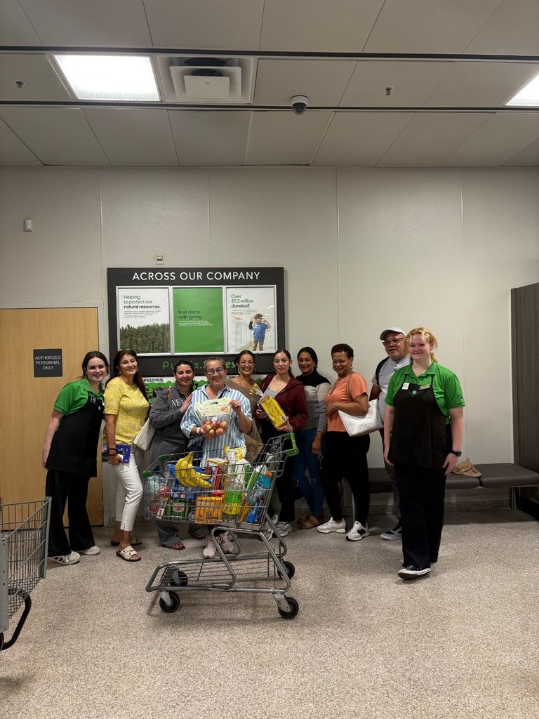 Ms. Dancy's class at publix with a shopping cart full of groceries