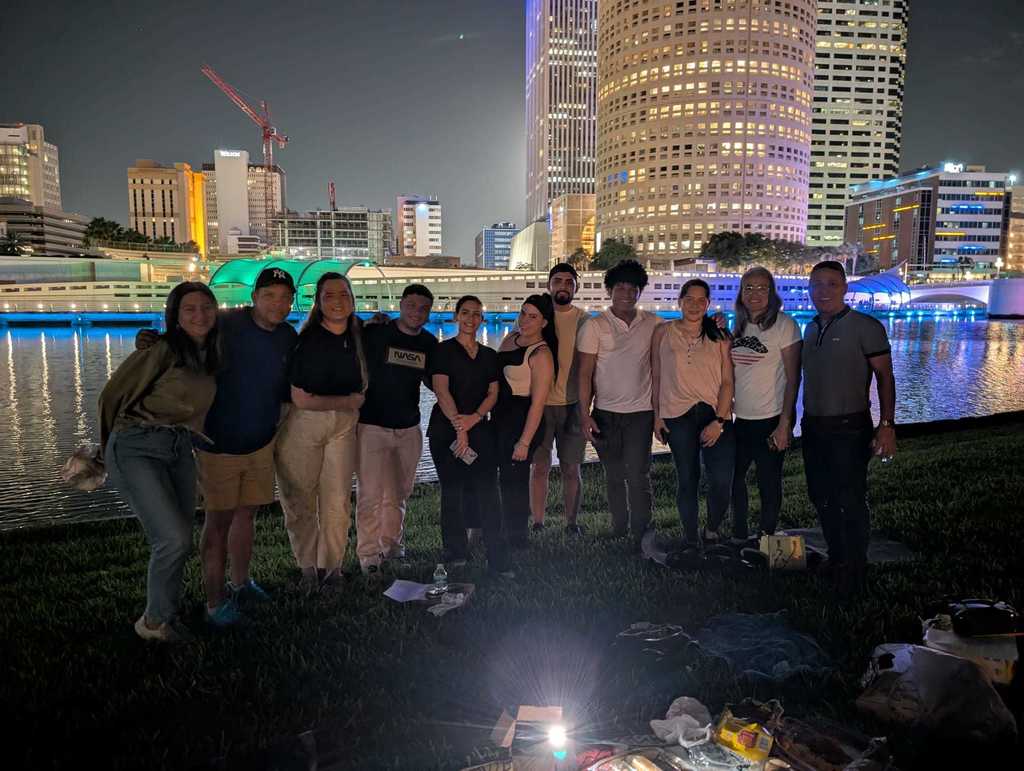 Students in front of tampa Riverwalk at night