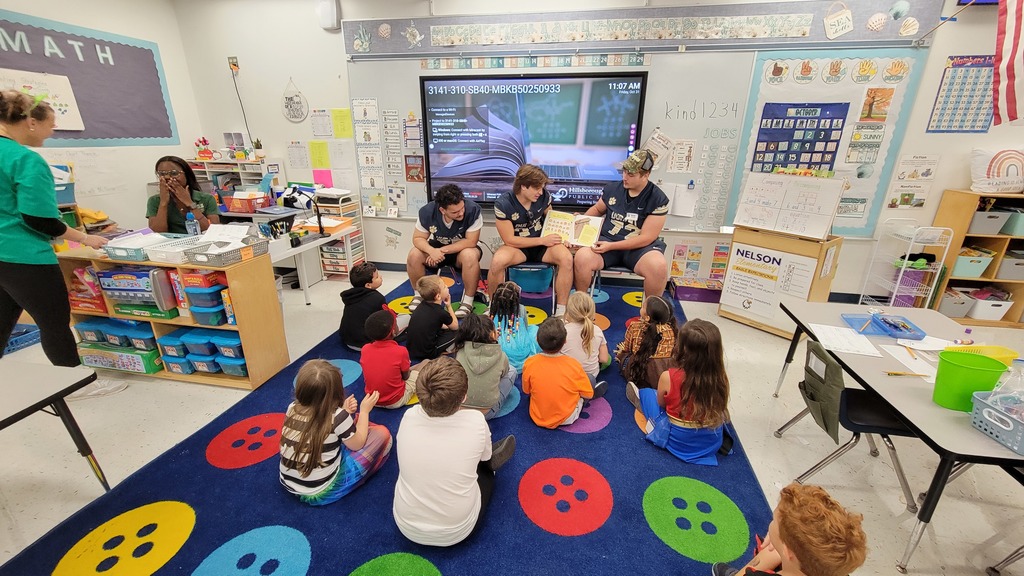 Football players read to students at Nelson Elementary