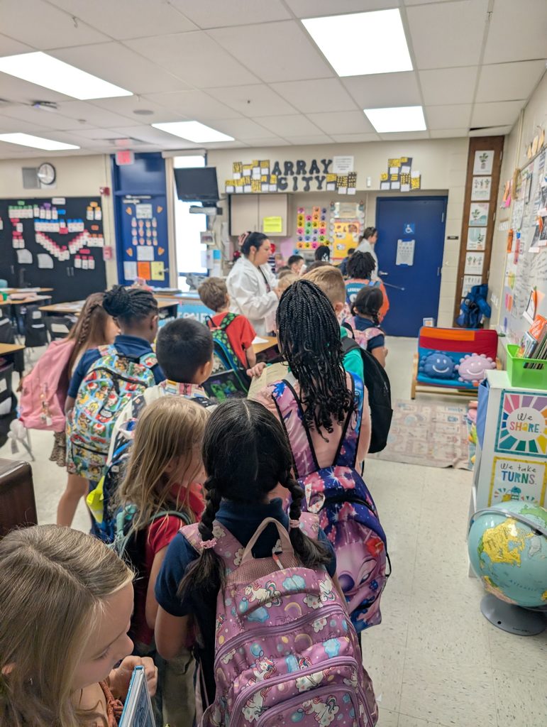 Students lined up with backpacks