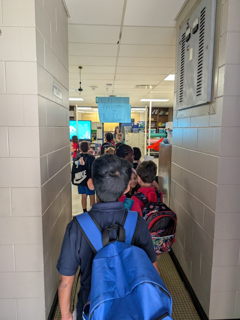 Students lined up with backpacks