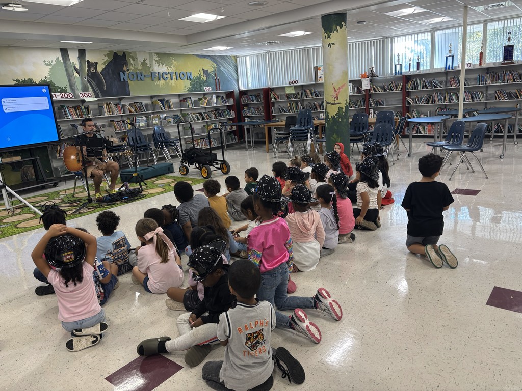 Students listening to a musician