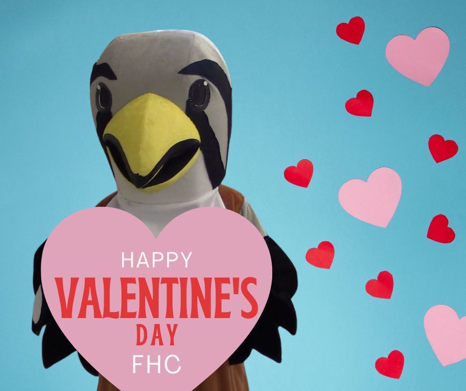 Falcon mascot holding a pink heart that says, "Happy Valentine's Day FHC". 