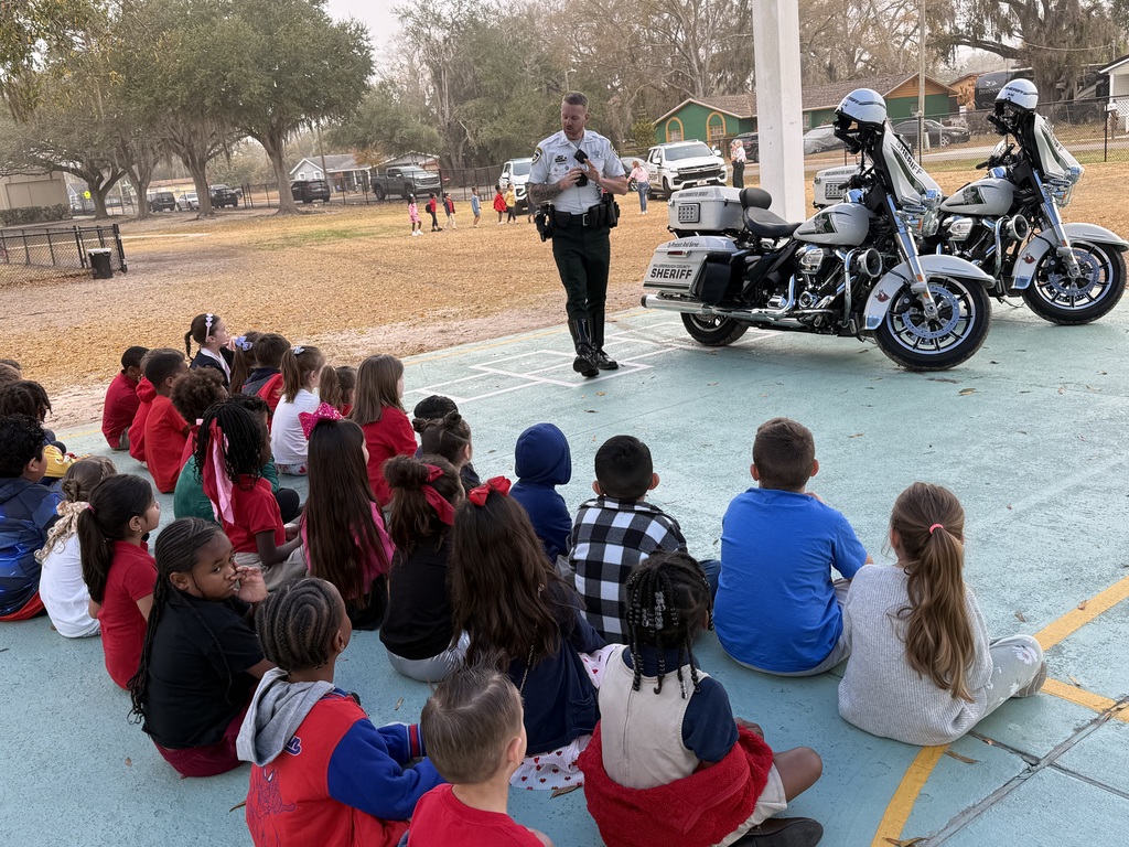 Kindergarten students learning about Hillsborough County Sheriff motorcycle officers