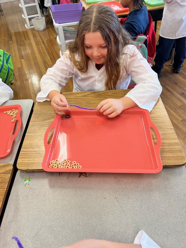 Students in 3rd grade building modeles of vertebrate and invertebrate animals