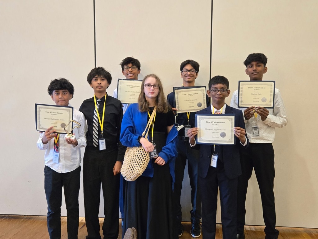 Students standing with awards