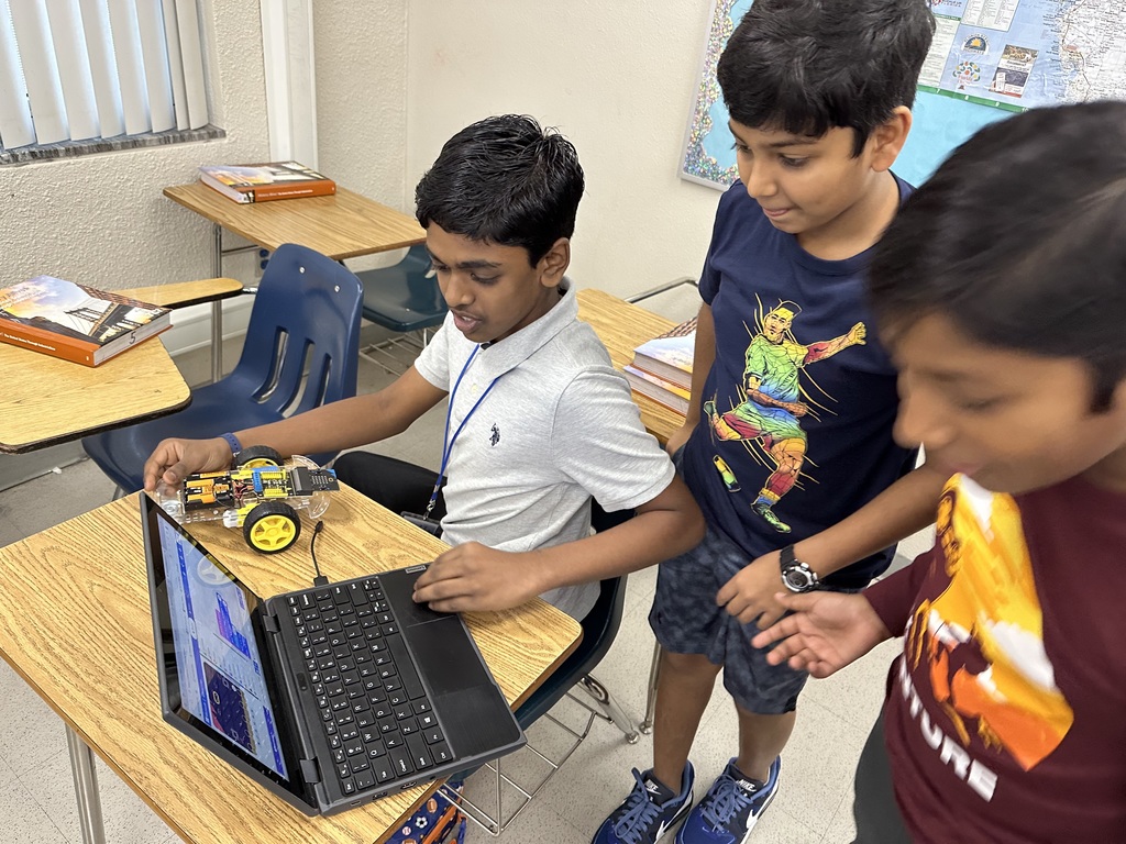 Students looking at a computer