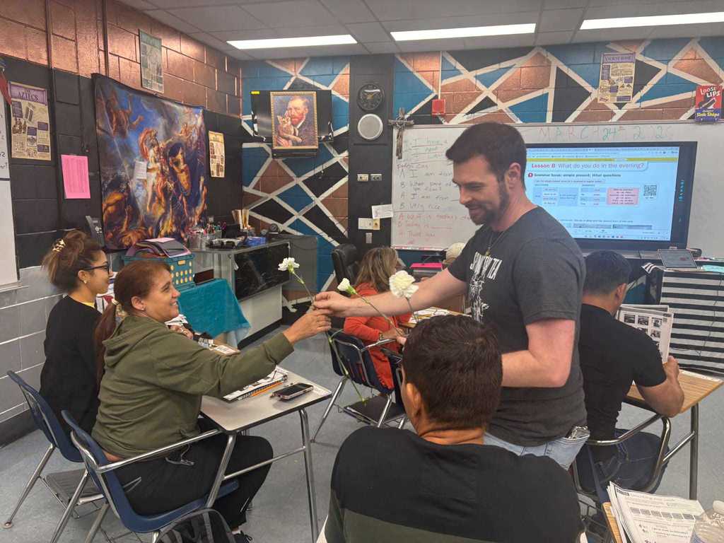 man giving woman a flower