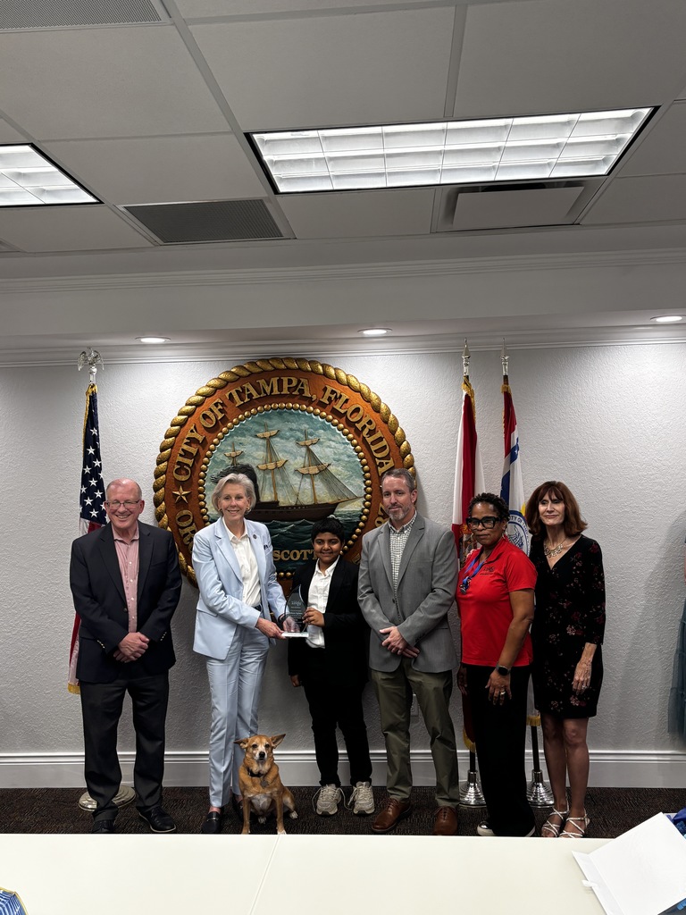 Student receiving an award from the City of Tampa and Mayor Castor