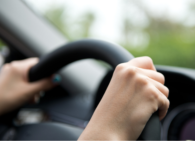 Photo of someone holding onto the steering wheel