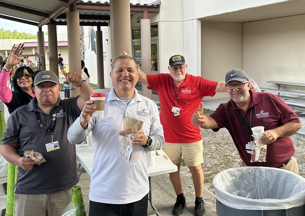 Picture of bus drivers enjoying gift card and goodies from PTSA and Krispy Kreme coffee and donuts compliments of Steinbrenner administration, faculty , and staff.