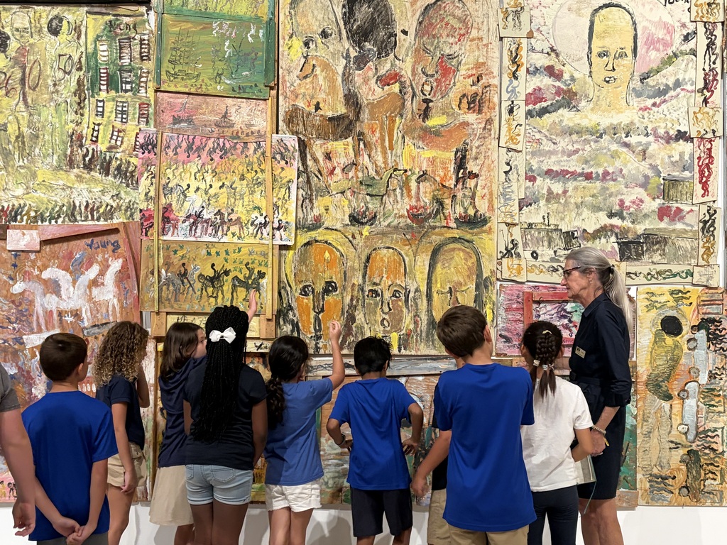 Group of students looking at a wall art installation 