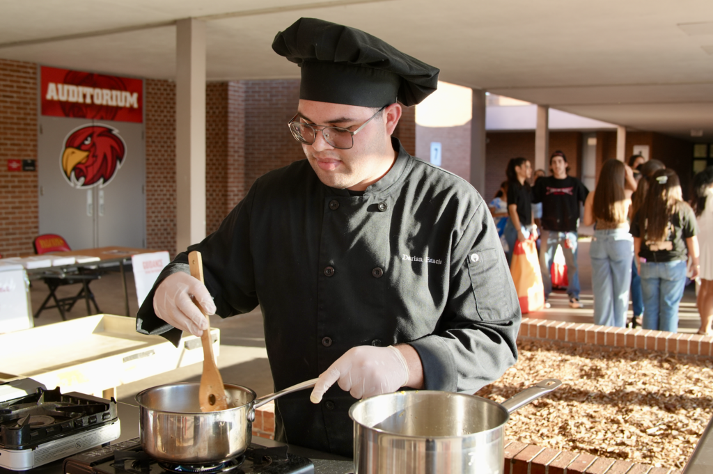 Student cooking at Hispanic Heritage Month Celebration
