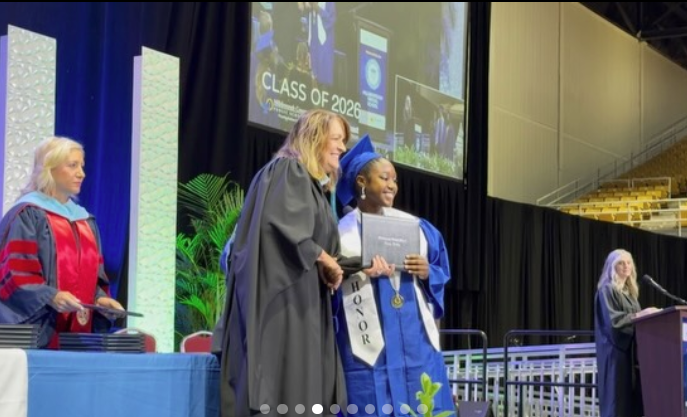Principal Upshaw giving diploma to student