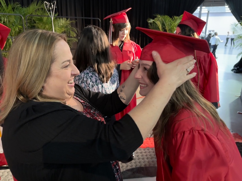 High school graduate with staff member
