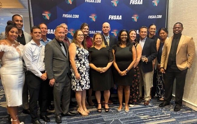 A group of people celebrating ROBINSON HIGH SCHOOL'S COACH JOSHUA SAUNDERS INDUCTED INTO FHSAA HALL OF FAME