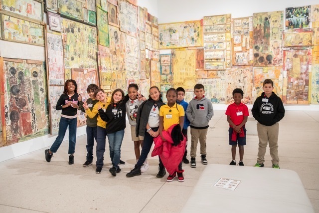 Group of students in front of works of art in a museum