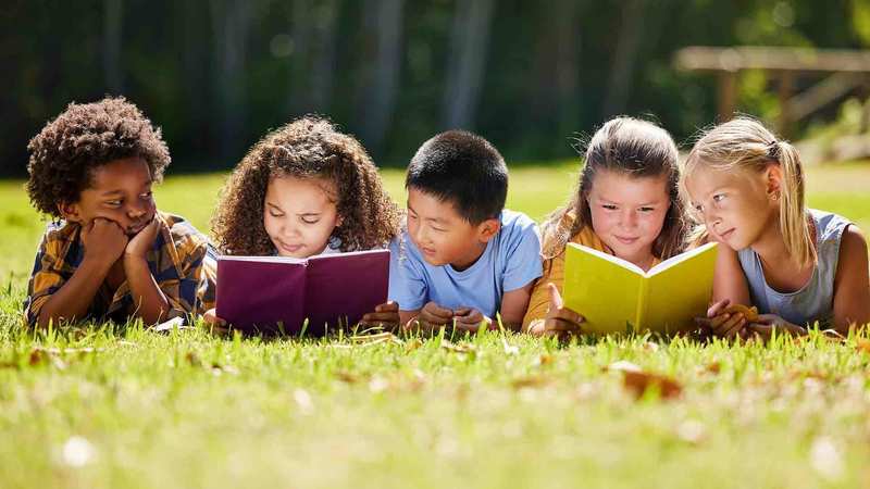 children reading outside