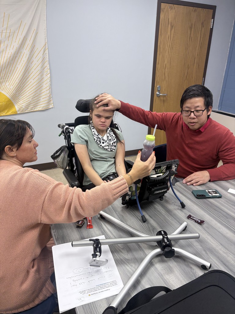 Student, parent and staff with new communication device