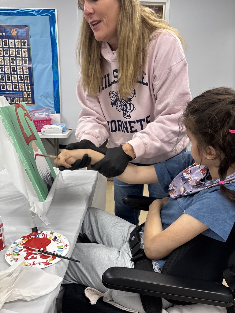 Teacher Helping Student Paint