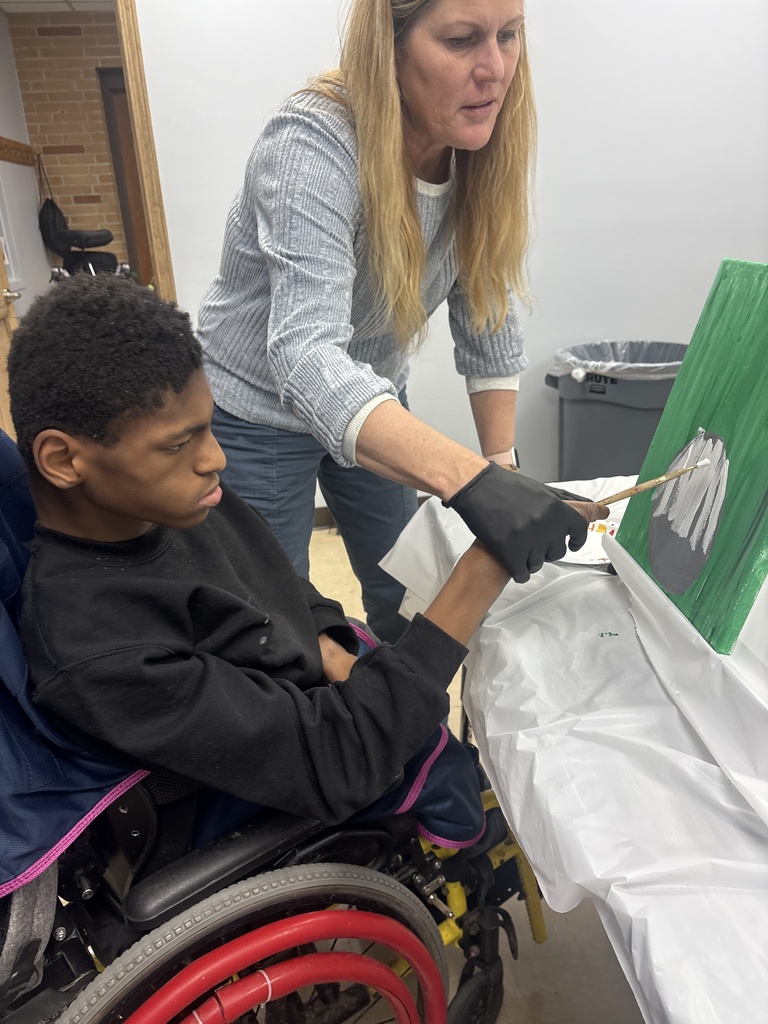 Teacher Helping Student Paint