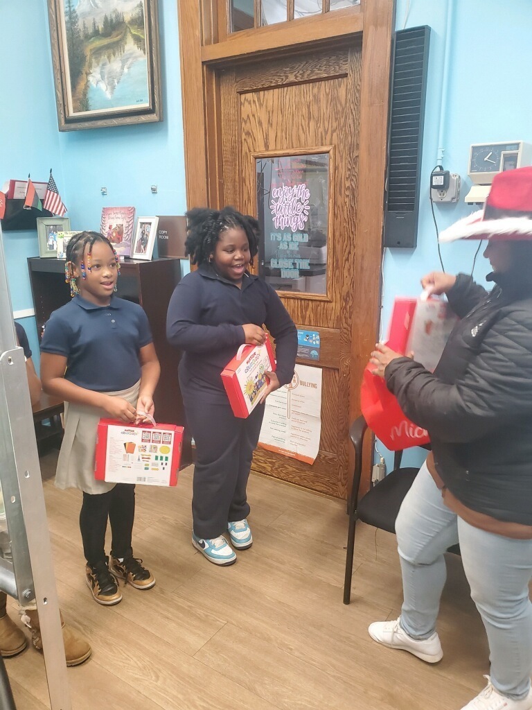 Board President Cook giving out toys to Hillside Public Schools students