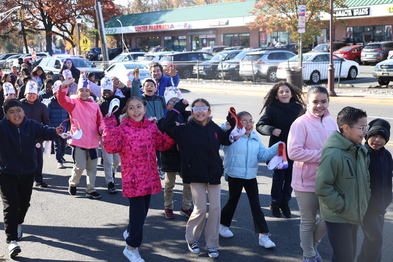 students waving at the camera