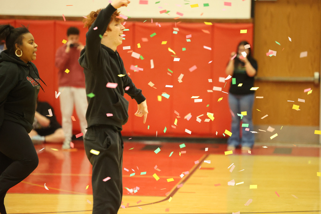Student dancing at Pep Rally with confetti coming down