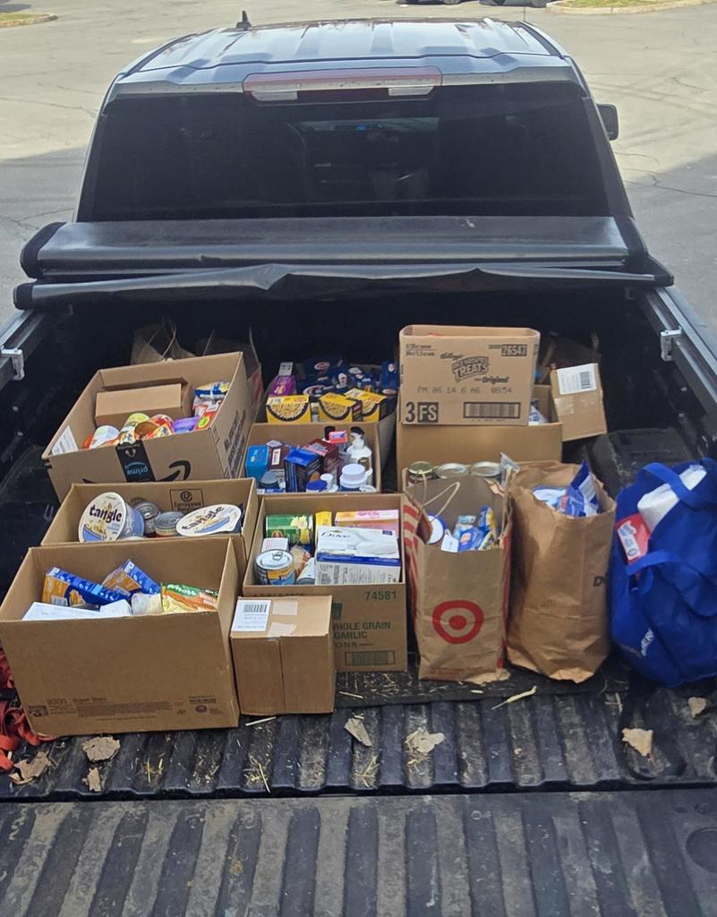 Bed of a pick up truck filled with donations for Food Cupboard