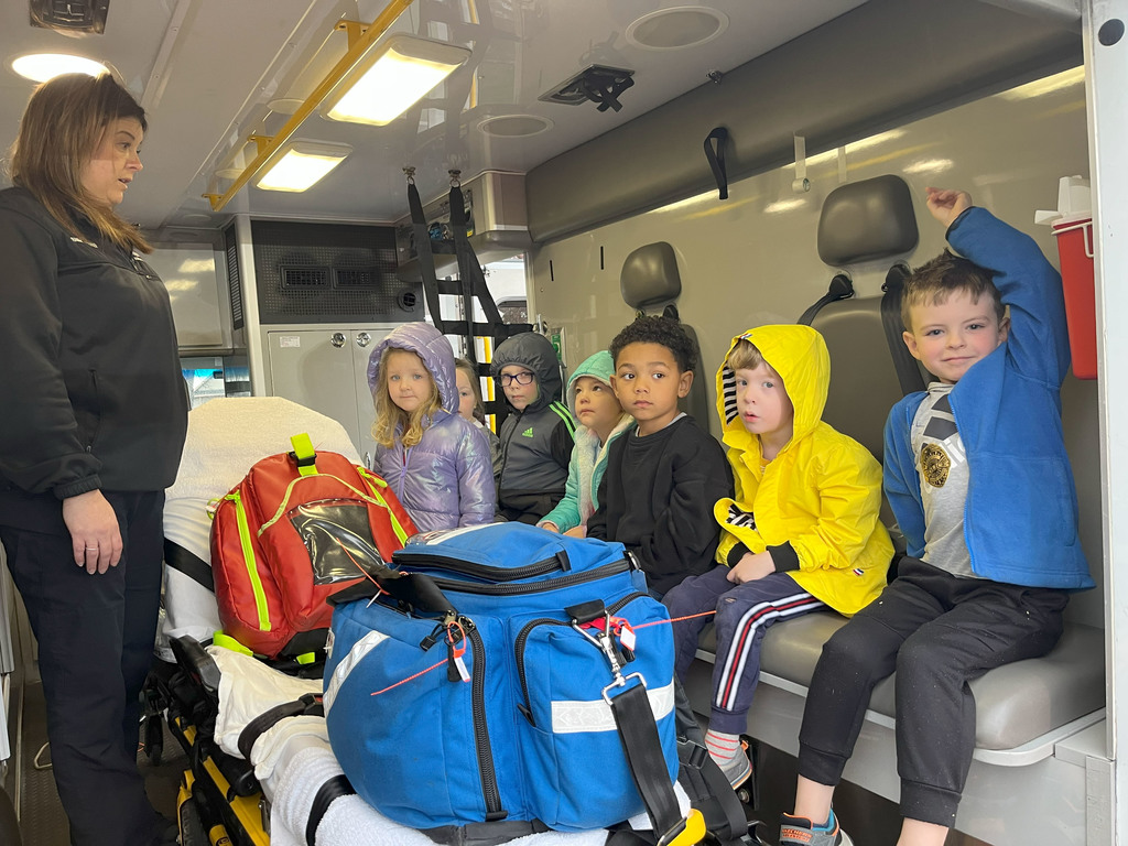 Students sitting in back of ambulance.