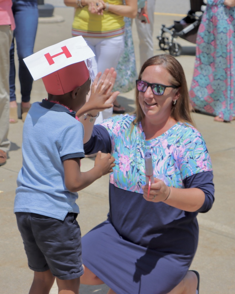 staff member high fiving student