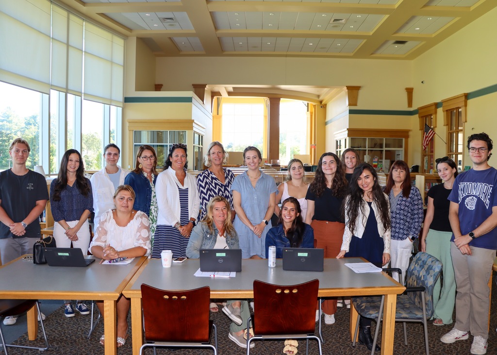 New paraeducators pose for a photo in the library.