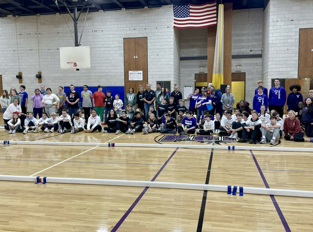 Picture of students sitting in a gym smiling at the plymouth unified bocce ball jamboree.