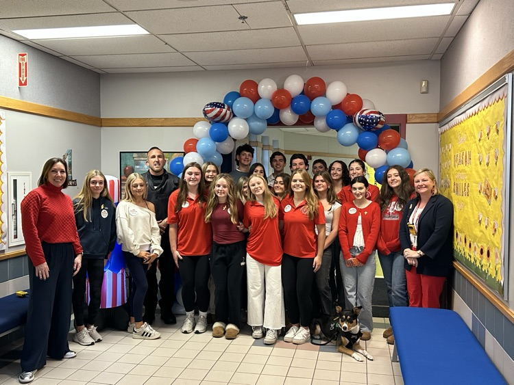 veterans appreciation club posing with South principle and school, resource officer, Tom, Ford, and Opry the comfort dog.