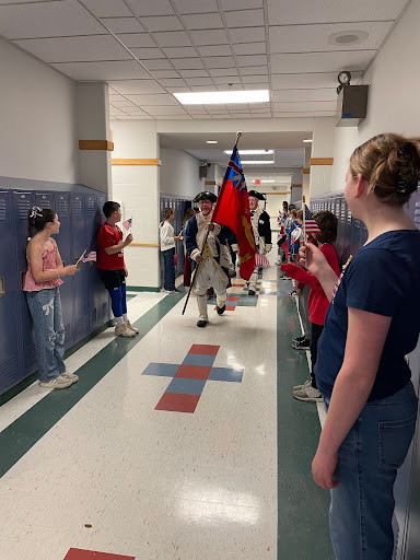 students line the hallway as Hingham militia processes through.