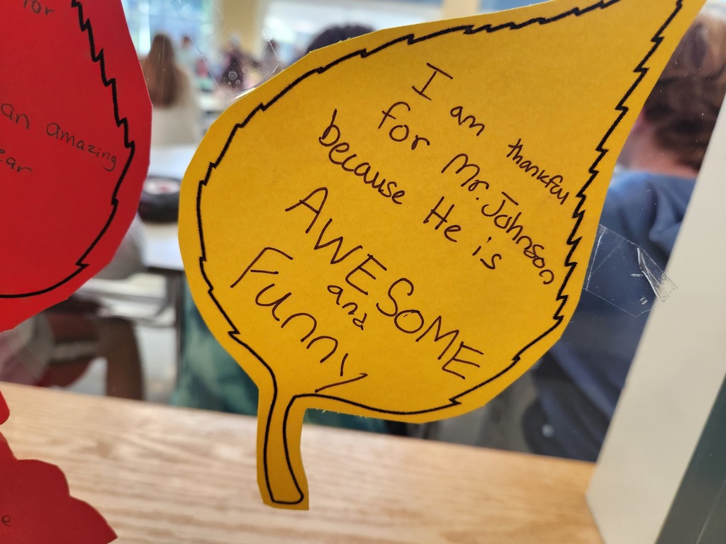 A gratitude  leaf that says " I am thankful for Mr. Johnson because he is awesome and funny."