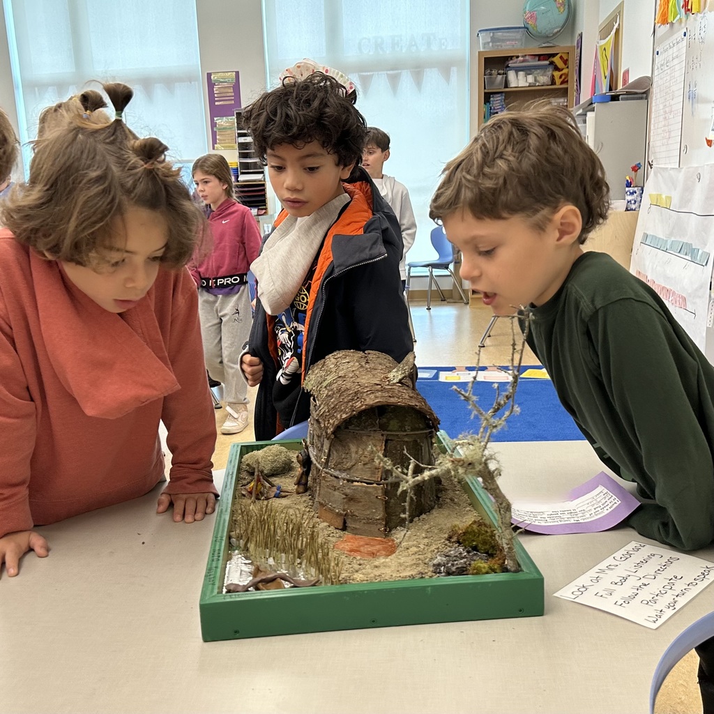 Student showing off his wetu creation to other students during the walkthrough.