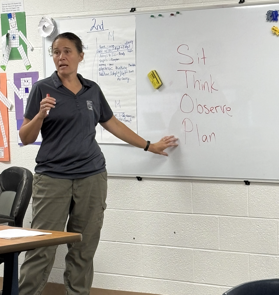 Naturalist Victoria teaching the acronym STOP (sit, think, observe, and make a plan)