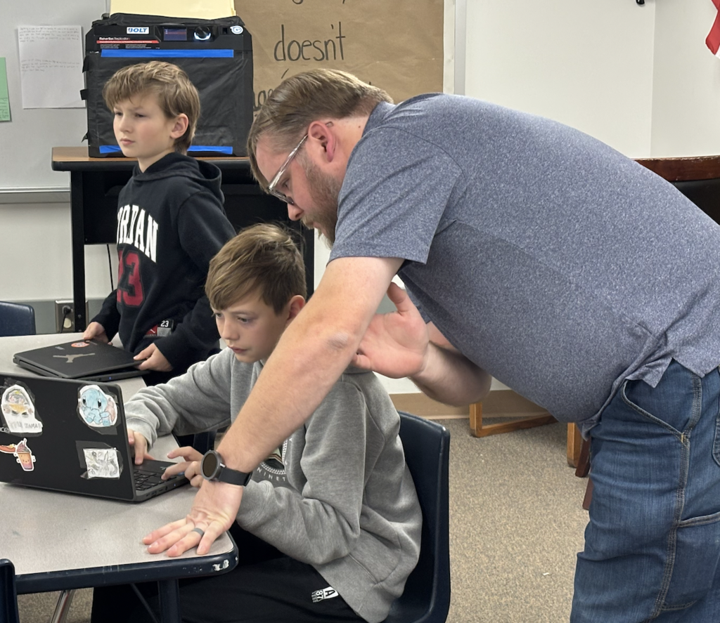 Jacob showing students how to use Tinkercad, a 3D printing software