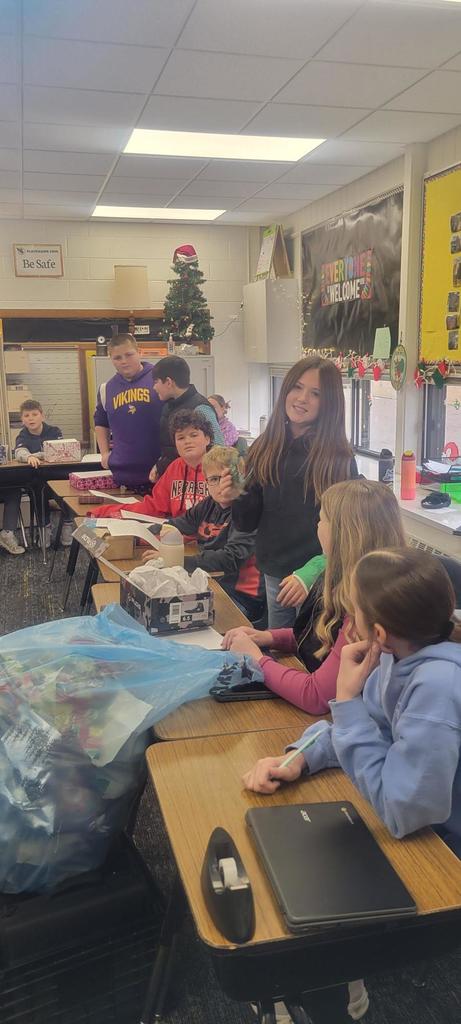 6th graders in Language Arts class opening presents for the gift exchange writing activity.