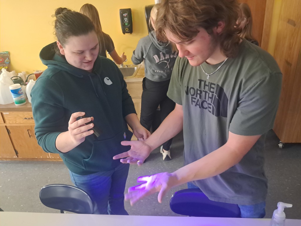 Observing the "germs" on their hands.