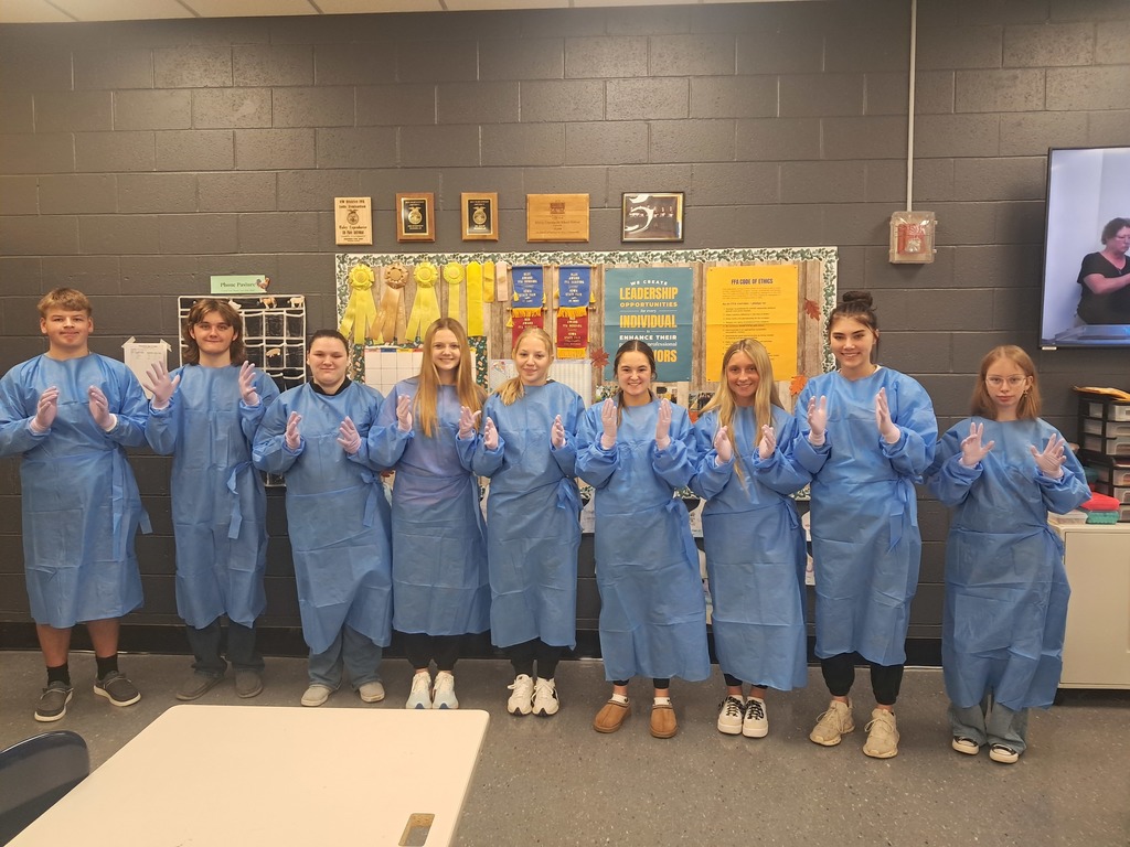 Vet Science donning surgical gowns 