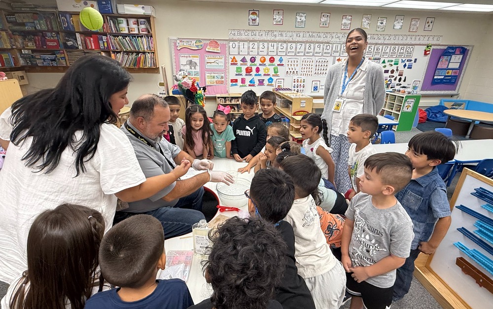 man with students and teachers