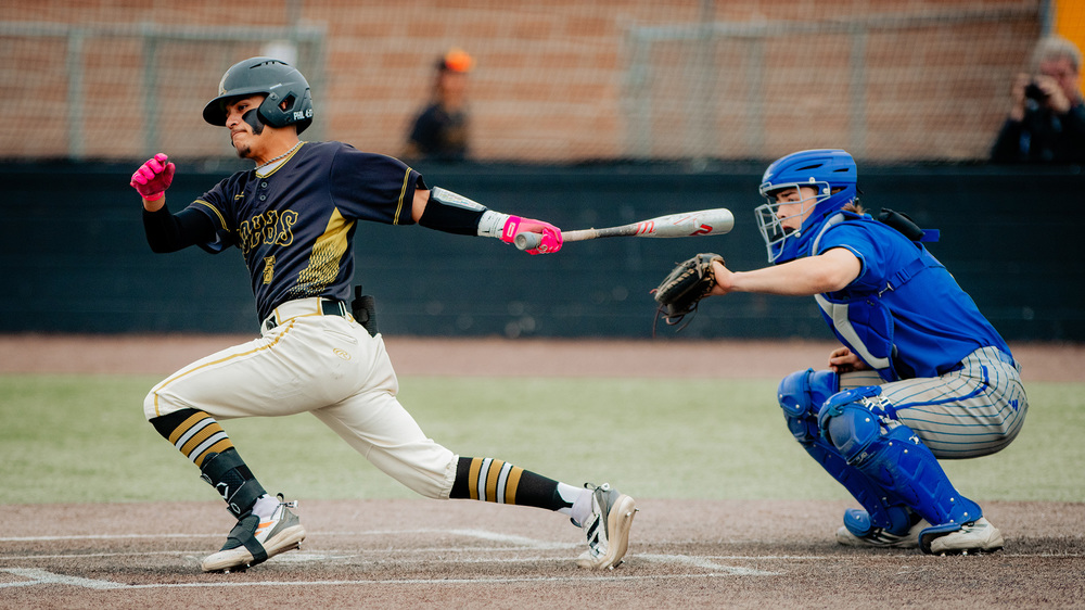 catcher and player hitting ball